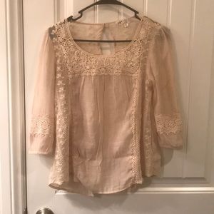 Sheer lacy cream blouse.